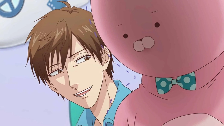 Uramichi smiling with a jaded expression next to the pink rabbit mascot